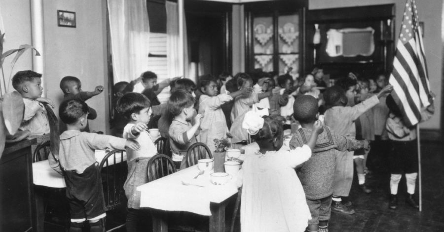 1939:  Children reciting the pledge of allegiance in an Elementary School classroom in Los Angeles, California.  (Photo by MPI/Getty Images)